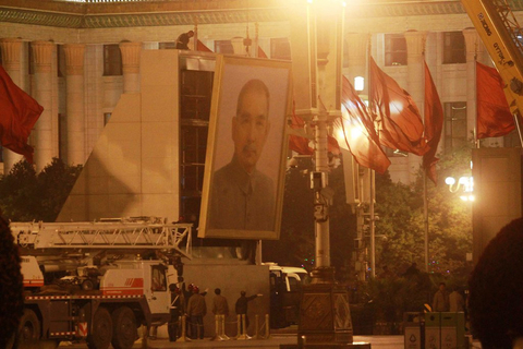 5月1日21点，六辆130卡车准点驶入北京天安门广场，停在孙中山画像前。随着“五一”小长假的收尾，天安门广场上六米高、近两吨重的“中山像”也如期搬回画像棚内。 CFP