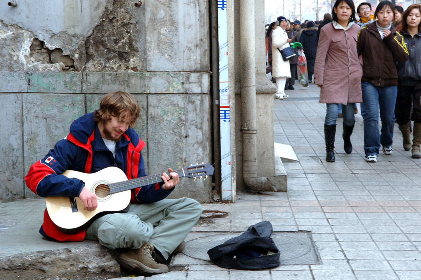 2006年2月12日，北京王府井步行街上，一位正在卖唱的外国人。 张朋/CFP_特辑：老外在北京