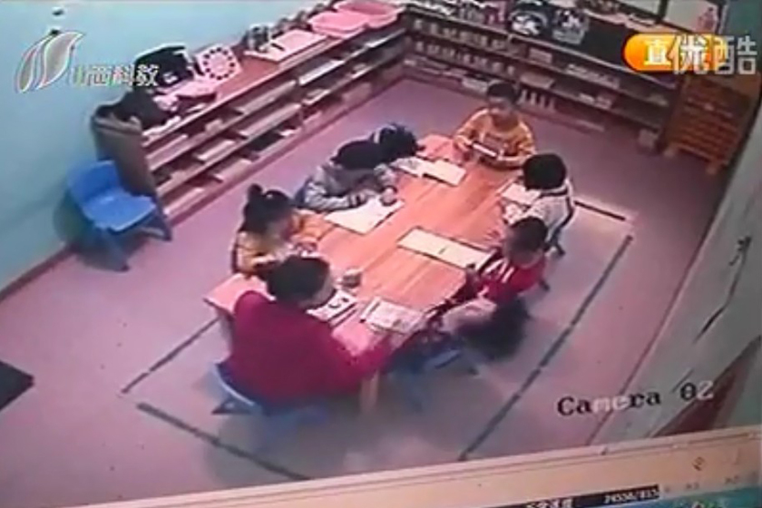 （截屏图）10月15日，监控录像显示，坐在幼儿园老师右手边的女童被扇耳光，半小时内被打了70多下。_太原五岁女童被幼儿园老师扇70耳光