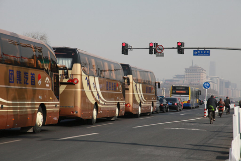 3月3日，2013年全国两会的第一天，前往人民大会堂的两会车队跟在公交车和私家车的后方，在西长安街上等待红灯放行。今年全国两会期间，北京市不会“封路、警车带道”，而是改为“交通管控腾道”措施。   中国网/CFP
