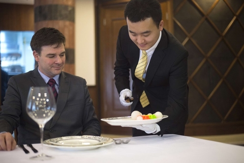 管家学校的学员戴白手套服务。 FRED DUFOUR/CFP