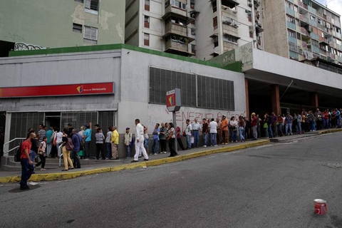People line up to get into a Banco de Venezuela branch in Caracas