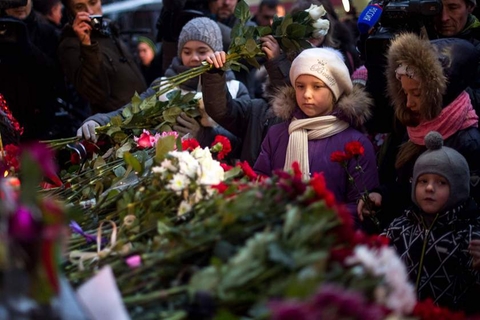 Children lay flowers at the home stage building of the Alexandrov Ensemble (The Red Army Choir)