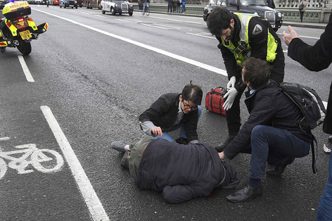 An injured person is assisted after an incident on Westminster Bridge in London